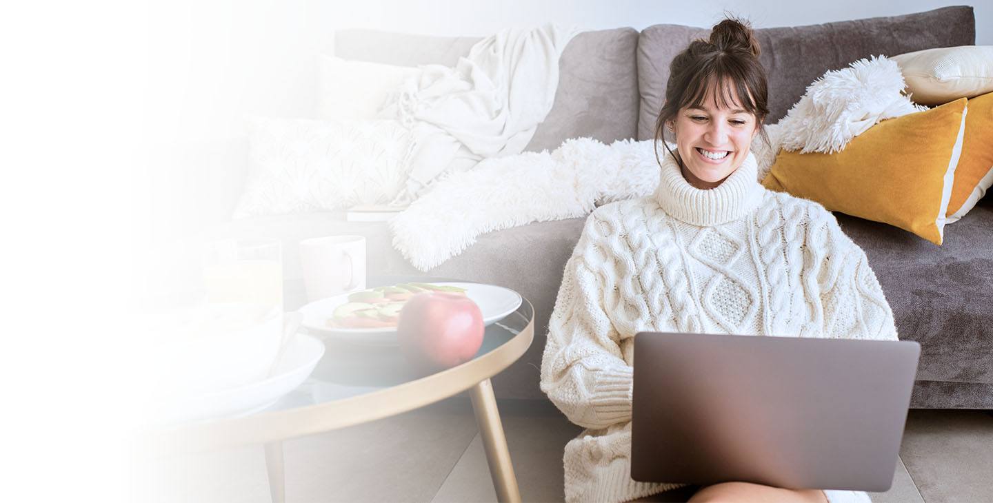 Woman enjoying Viasat’s fast home satellite internet on laptop