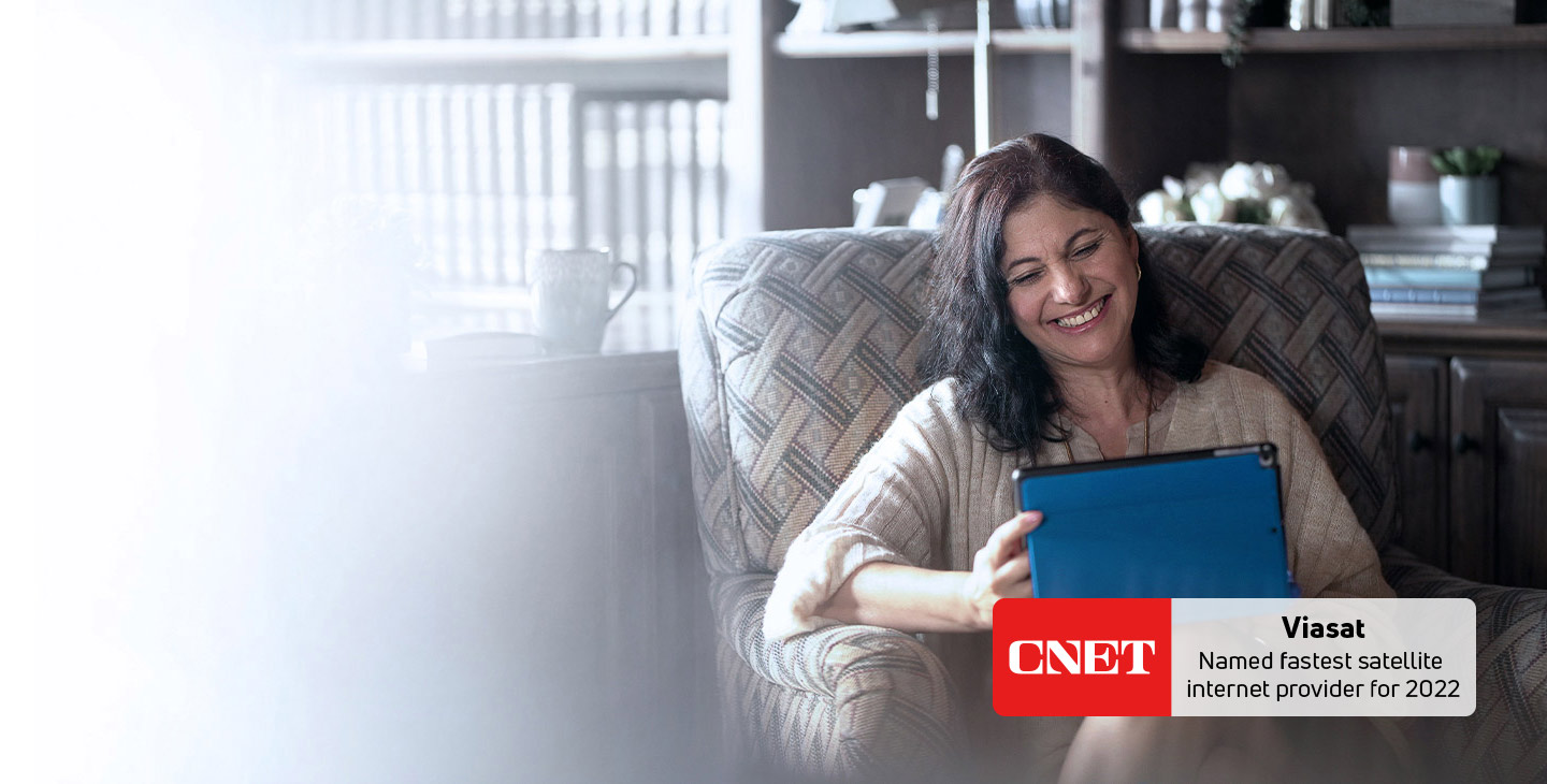 Woman connected to her tablet with Viasat Internet's built-in Wi-Fi