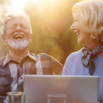 Man and woman enjoying staying connected with Wi-Fi from their Viasat internet service