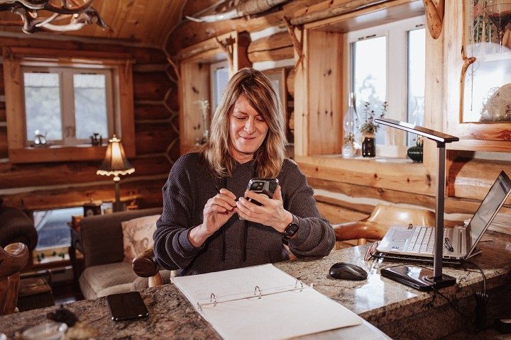 Home satellite internet customer connects multiple devices using her Wi-Fi enabled modem from Viasat