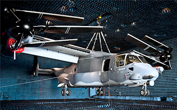 Grey colored military helicopter inside of a testing facility